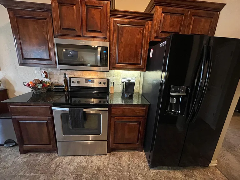 Beautiful kitchen is entertainers delight with generous counter space and tons of cabinets/storage plus a pantry.