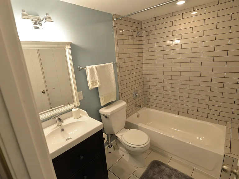 Custom tiles bathroom, bathtub with bench.