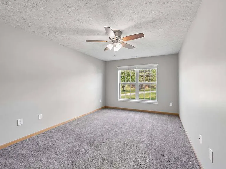 A spacious bedroom with soft natural light and a peaceful atmosphere offers the perfect place to relax and recharge.
