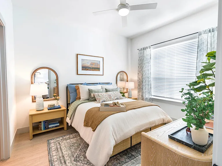 Experience a calming retreat in your bedroom with oversized windows, warm natural light, and space to unwind.