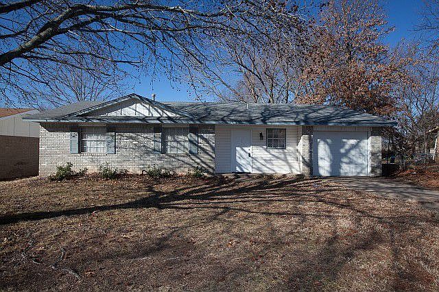 Mature trees drape over this homey place 