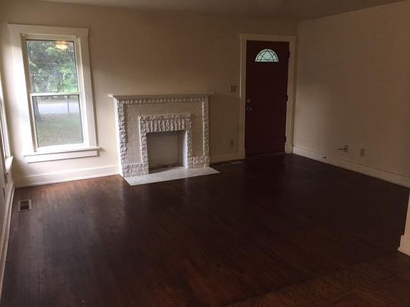 Living room with decorative-only fireplace.