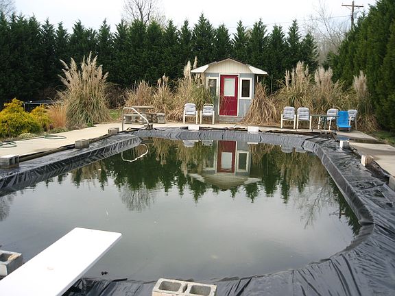 18x42 oval in-ground pool with extensive concrete