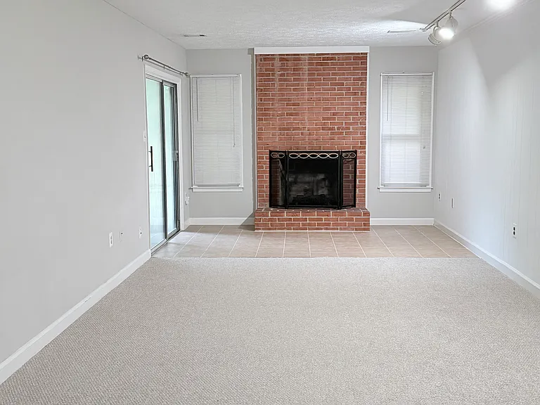 Basement open area with sliding door and wood fireplace