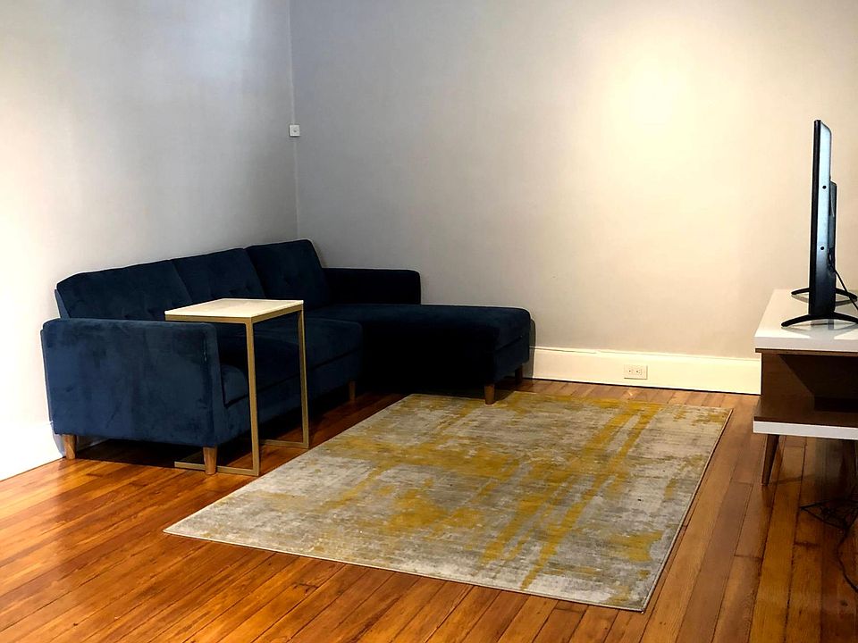 Living room with hardwood floors and remote controlled ceiling fan