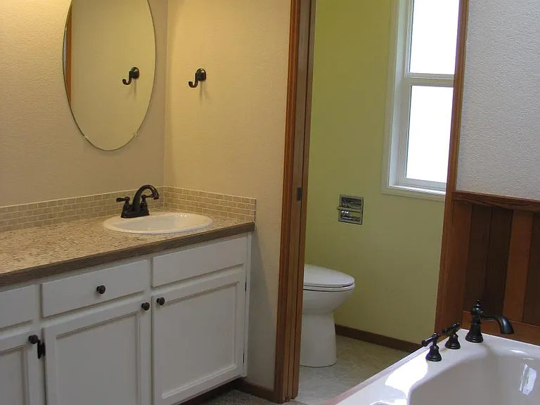 double sink master bathroom, soaking tub and pocket door to shower and toilet