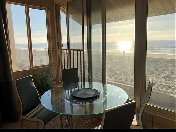 Portion of dining and living room area that's close to the beach with amazing views of everything.