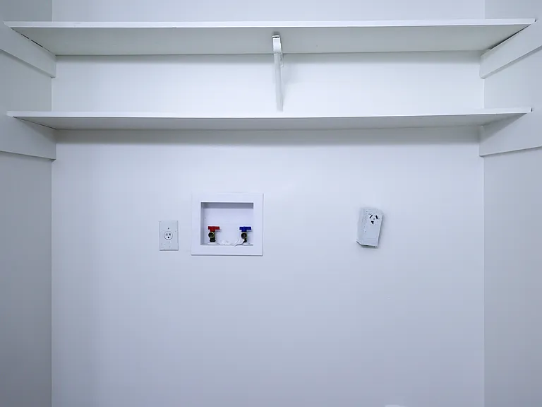 Laundry area with storage shelving
