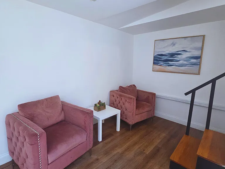 Two inviting armchairs and a coffee table create the perfect relaxation spot.