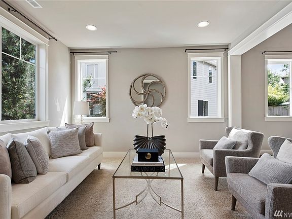 Formal living room infused with lots of natural light from an abundance of windows.