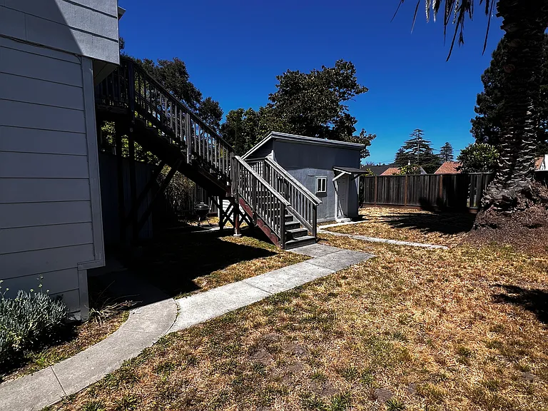 Backyard shed and stairway up to unit 3