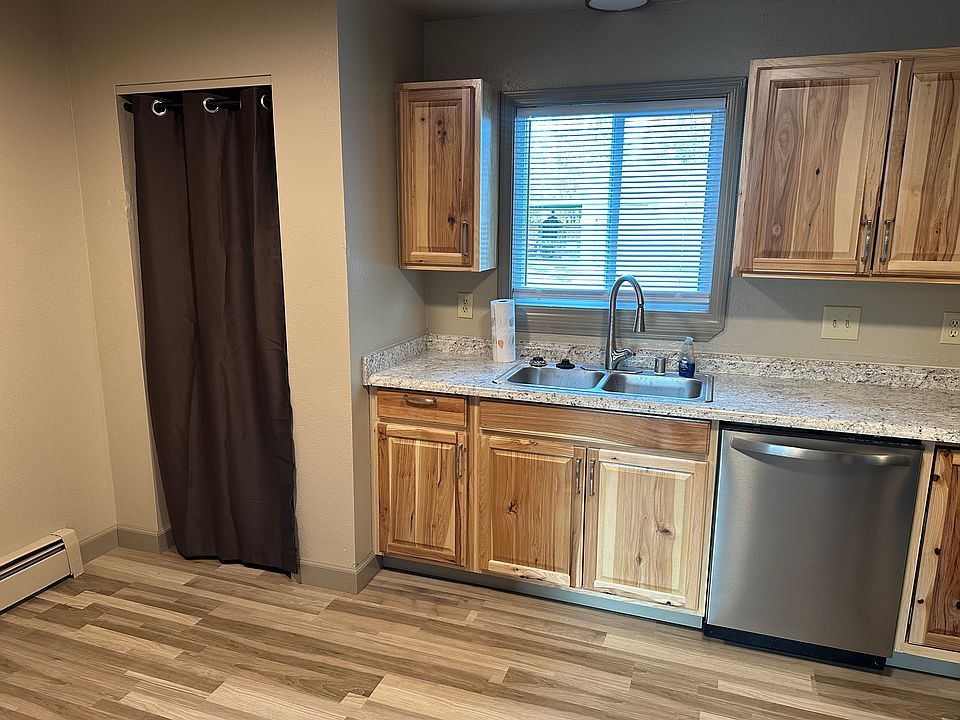 Kitchen with new cabinets and appliances. The curtain to the left is the pantry.