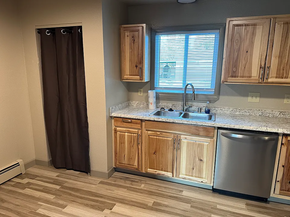 Kitchen with new cabinets and appliances. The curtain to the left is the pantry.