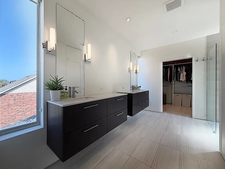 Primary bath features two vanities for ultimate storage.