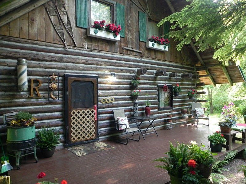The spacious front porch welcomes friends into this charming log home on 2.5 acres. There are several outbuildings on the property including a Carport/Shop area with parking for 4-6 vehicles.