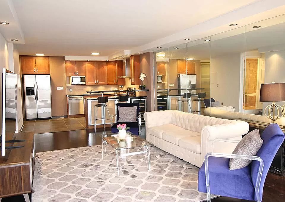Living room - open floor plan to kitchen and floor to ceiling windows