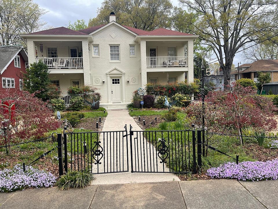 BEAUTIFUL french cream painted brick exterior with landscaped yard