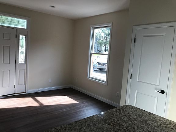 Dining area, with the front door on the left and a coat closet on the right.
