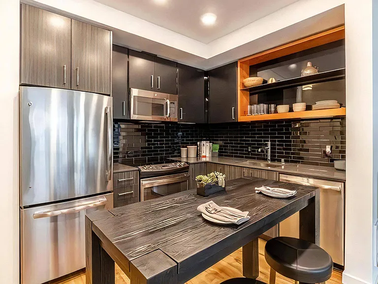 Built-In Appliances and Overhead Lighting in Open Kitchen Layout