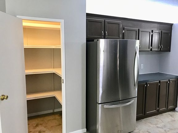 kitchen pantry, refrigerator, cabinets opposite sink and range