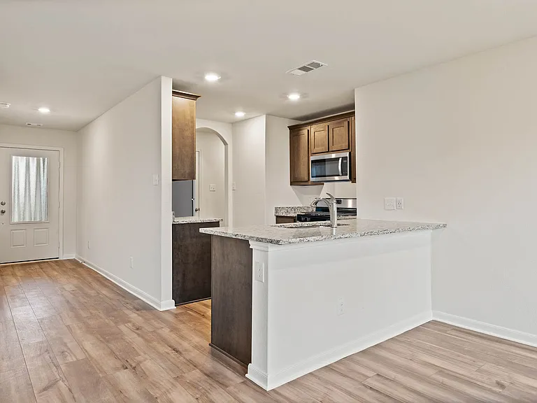 The kitchen has a wonderful breakfast bar that provides more counterspace and seating.