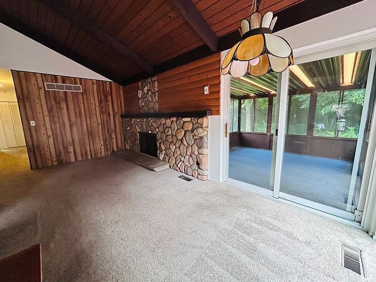 Fireplace room with view through sliders to sunroom
