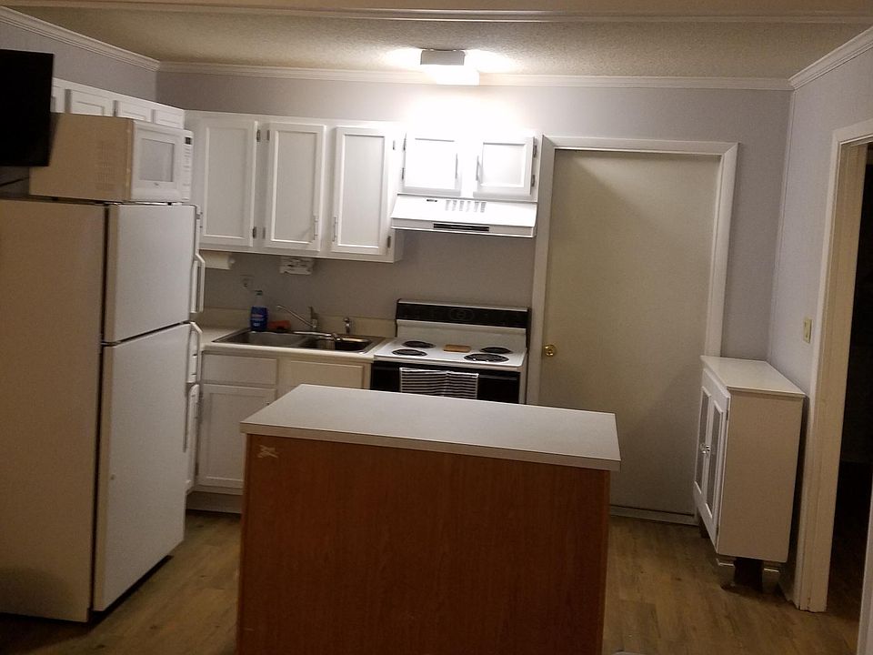Kitchen with freshly painted cabinets and new hardware.