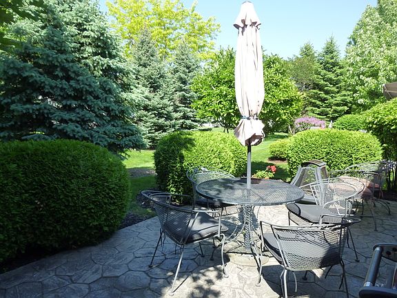 Lush mature landscaping with huge stamped concrete Patio