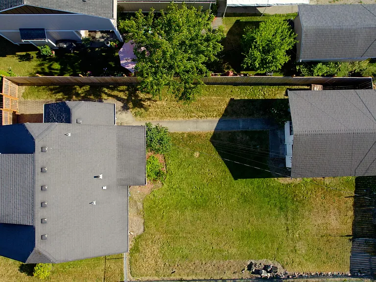 Home w/ detached garage on large double lot w/ fully fenced gated yard for additional parking if needed.