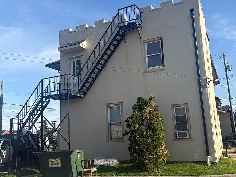 Back of the building, fire escape, 1 parking spot, garbage