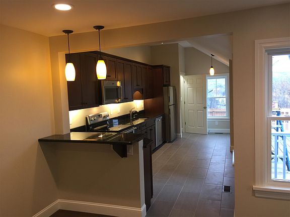 Kitchen with granite counter tops, cherry cabinet, and Energy Star stainless steel appliances