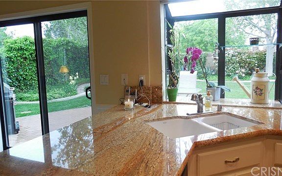 The garden window and slider reveal the beautiful back yard!