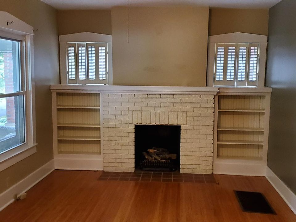 Living room with hardwood floors and gas fireplace & closet.