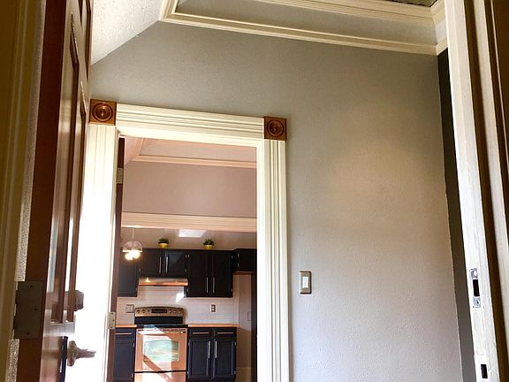 Apartment entrance going into foyer going into living room g