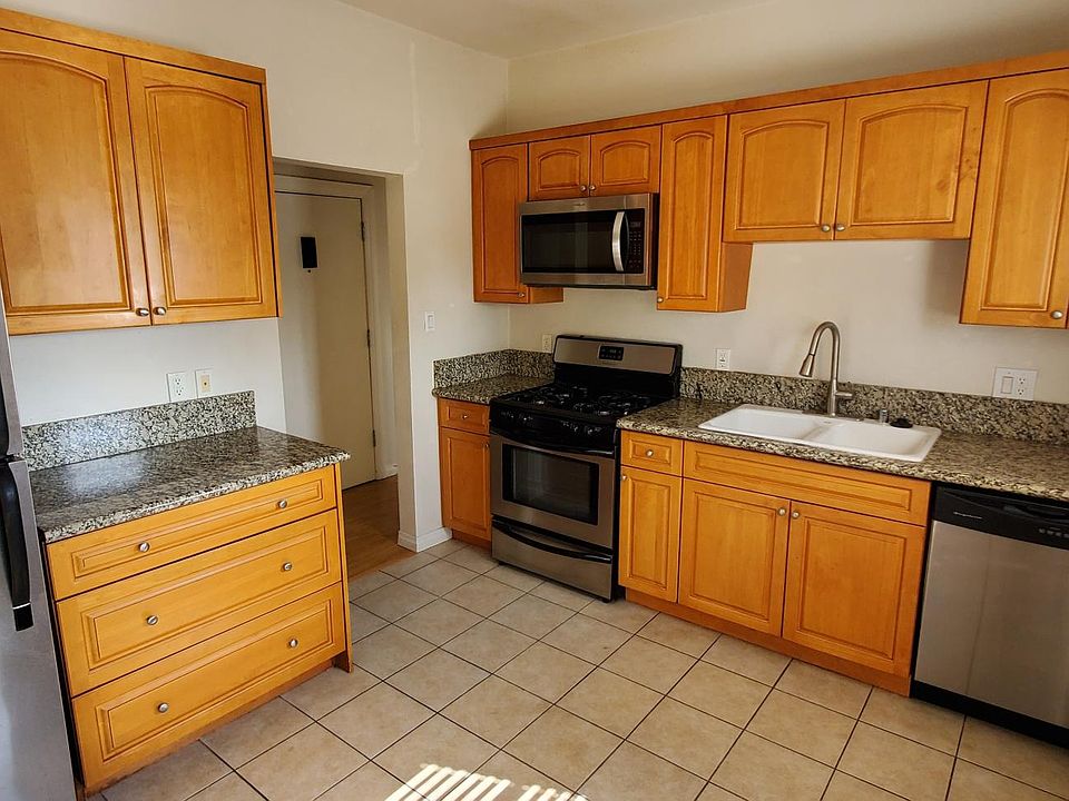 Kitchen with hardwood cabinets, granite countertops and stainless steel appliances