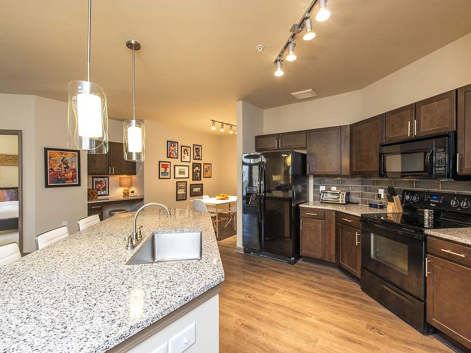 Luxurious Kitchen with Large Island, Pendant Lighting and Designer Tile Backsplash | Nashville Tennessee Apartments for Rent | 909 Flats
