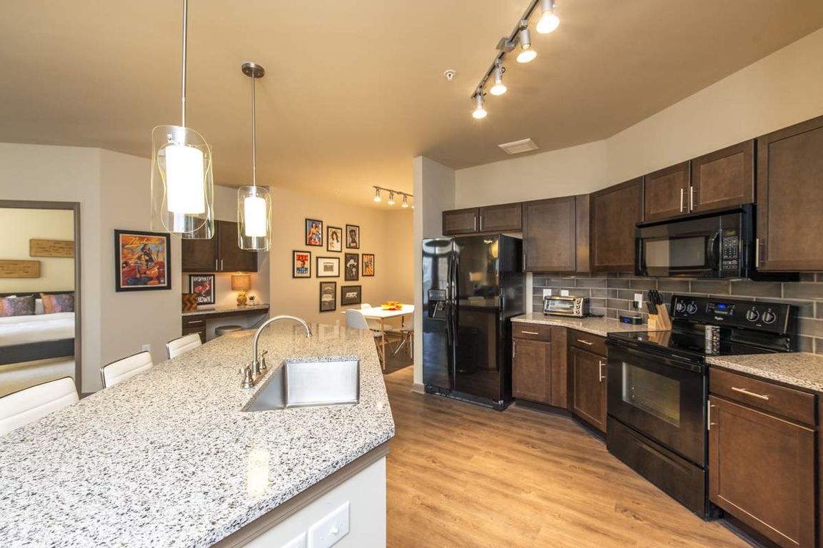 Luxurious Kitchen with Large Island, Pendant Lighting and Designer Tile Backsplash | Nashville Tennessee Apartments for Rent | 909 Flats