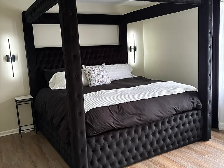 Primary bedroom with accent lighting and ceiling fan.