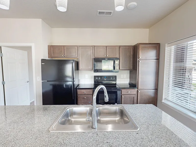The Retreat kitchen includes a large kitchen island, modern appliances, pendant lighting, and plenty of cabinet space. The Retreat kitchen includes a large kitchen island, modern appliances, pendant lighting, and plenty of cabinet space.