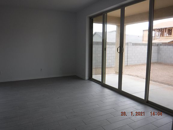 Living Area with bi-fold sliding door to patio.