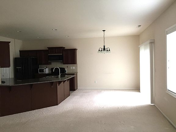 Main living space facing dining area and kitchen.