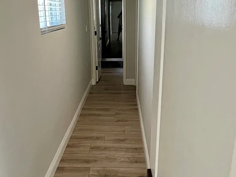 Hallway from den to separate wing with bedrooms #4 and #5 and bath #3.