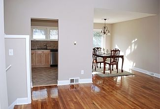 Living rm w/refinished wood floors & neutral paint