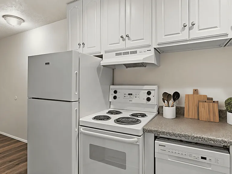 Bright and functional kitchen, staged with clean white appliances, ample cabinet space, and modern countertop accents. Bright and functional kitchen, staged with clean white appliances, ample cabinet space, and modern countertop accents.