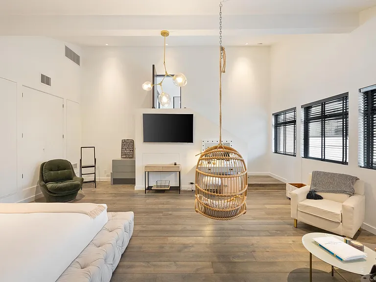 This guest bedroom boasts a generous lounge area with a flat-screen TV, for your enjoyment!