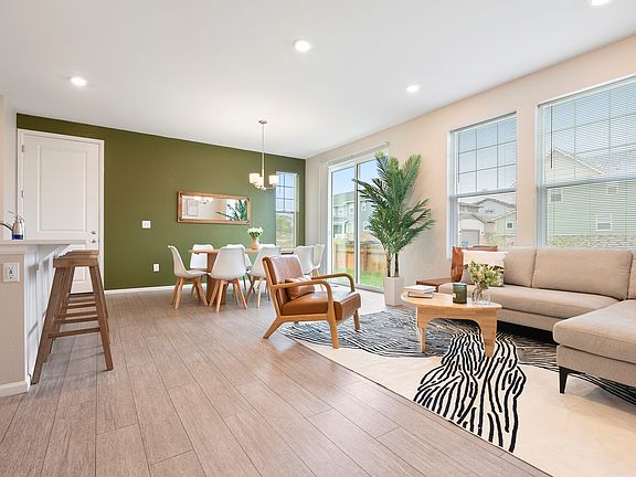 Modern, airy living & dining room with natural light, stylish decor, and cozy seating. Perfect for families & travelers. Near parks, shops, DIA and hospitals. Comfortable, bright space for your stay. Book now!