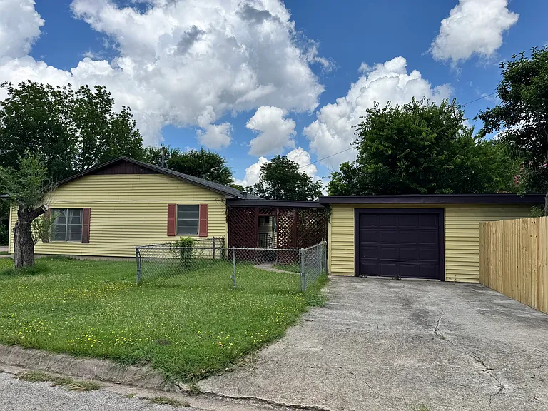 side of residence with garage view
