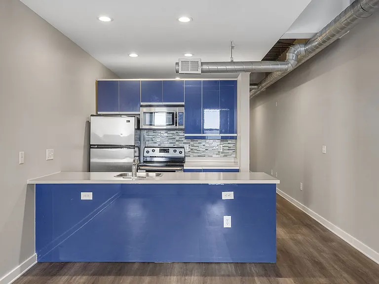 Our Apartment Kitchen with Blue Cabinets at Sleek Lofts Apartments in Denver, Colorado