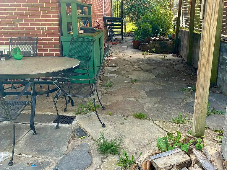 Cover patio, workbench, small pond (not shown), landscaped edging toward back.