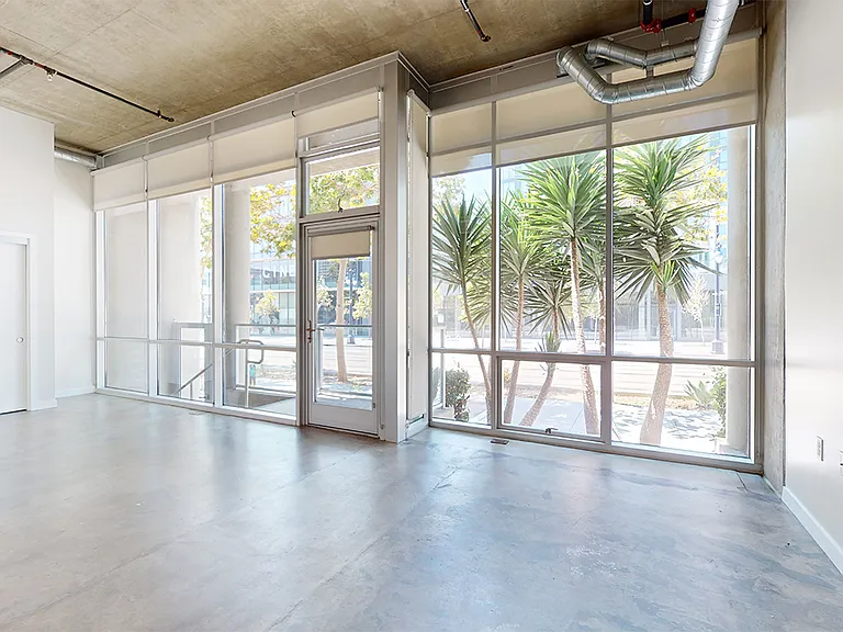 Apartment living room with polished concrete flooring.